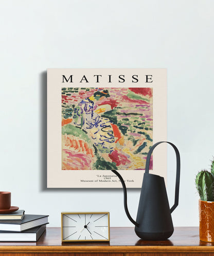 Henri Matisse La Japonaise canvas on a desk with a watering can, clock, and books, adding a fine art touch to interiors.