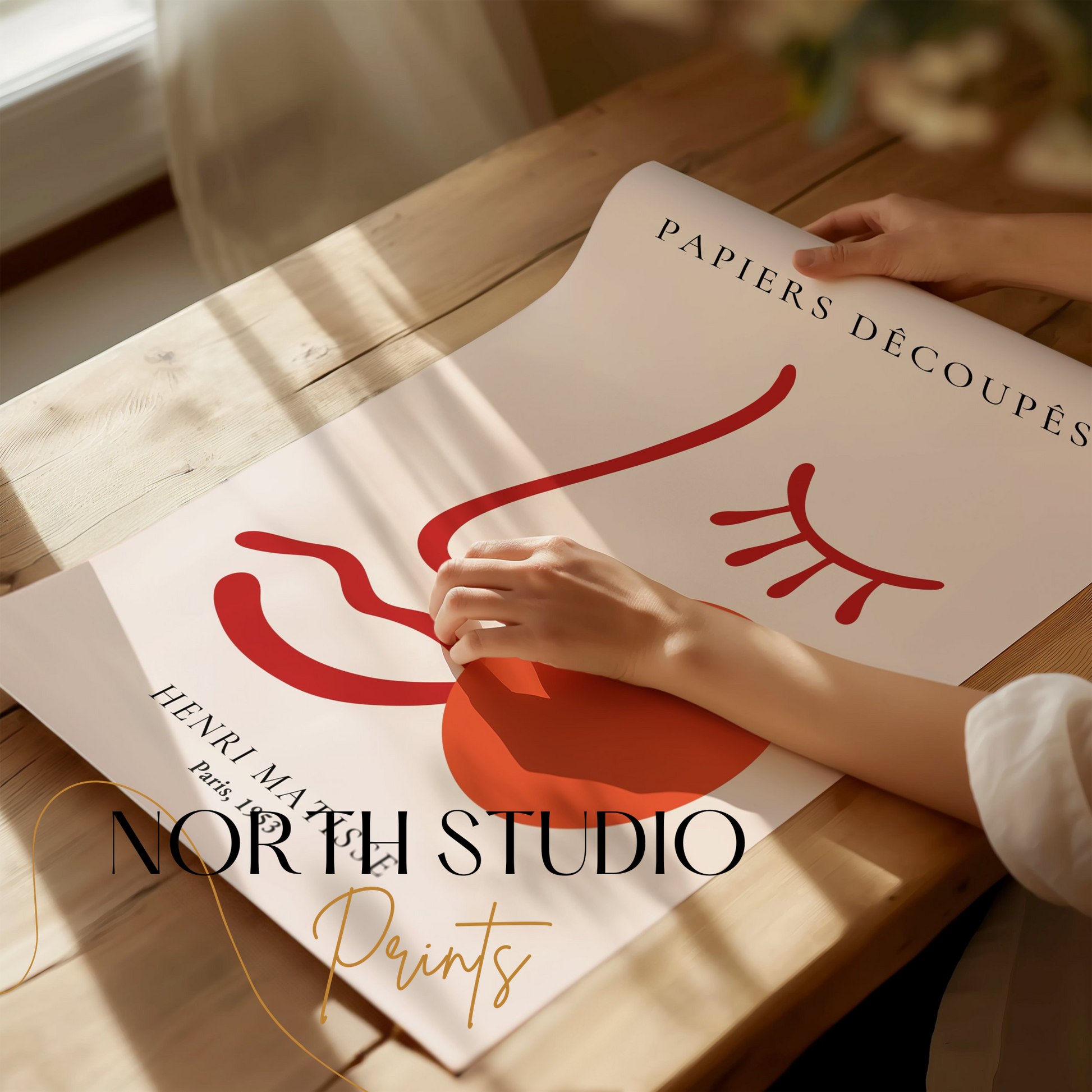 Henri Matisse Papiers Decoupes Paris 1953 art poster being unrolled on a wooden table, showcasing its minimalist red abstract design.