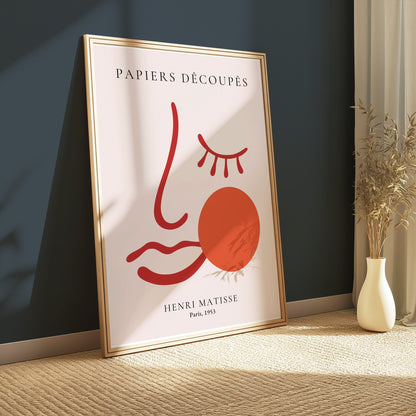 Framed Henri Matisse Papiers Decoupes Paris 1953 art poster leaning against a dark green wall, styled with natural light and modern decor.