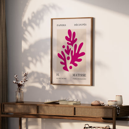 Framed Henri Matisse Paris France 1955 Papiers Découpés poster displayed on a wooden console in a modern living room with natural decor.