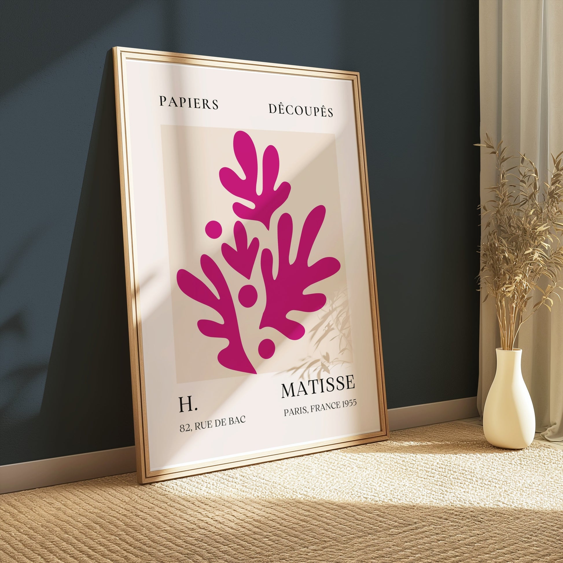 Henri Matisse Paris France 1955 Papiers Découpés poster in a wooden frame leaning against a dark green wall, styled with soft lighting and decor.