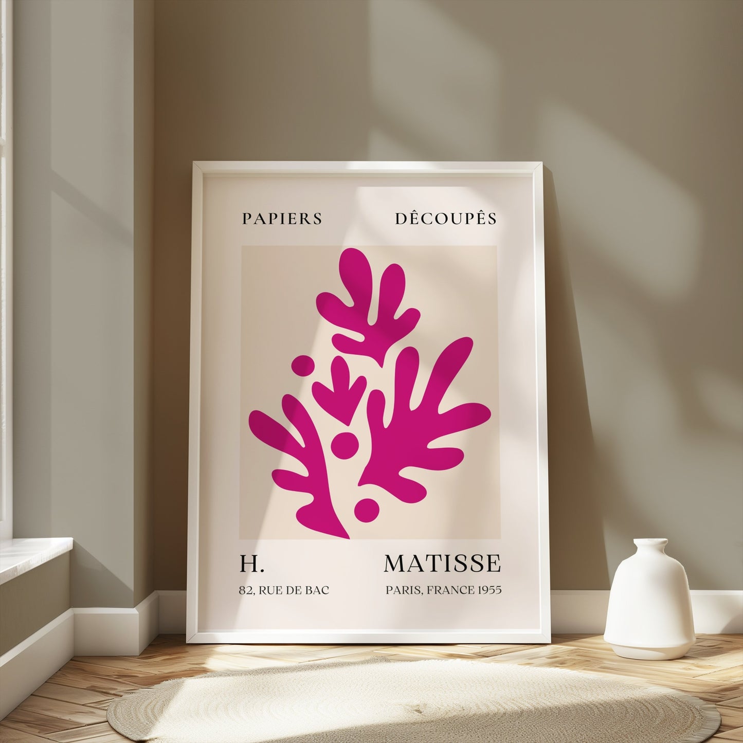Henri Matisse Paris France 1955 Papiers Découpés poster in a white frame leaning against a light gray wall, styled with soft natural lighting.