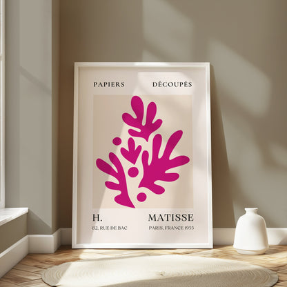 Henri Matisse Paris France 1955 Papiers Découpés poster in a white frame leaning against a light gray wall, styled with soft natural lighting.