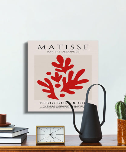 Henri Matisse Papiers Decoupes canvas art styled on a wall with a watering can and books, featuring bold red abstract shapes.