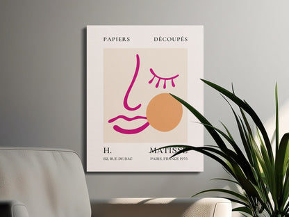 Henri Matisse canvas wrap with minimalist face design, styled on a wall next to a plant and modern furniture for home decor.