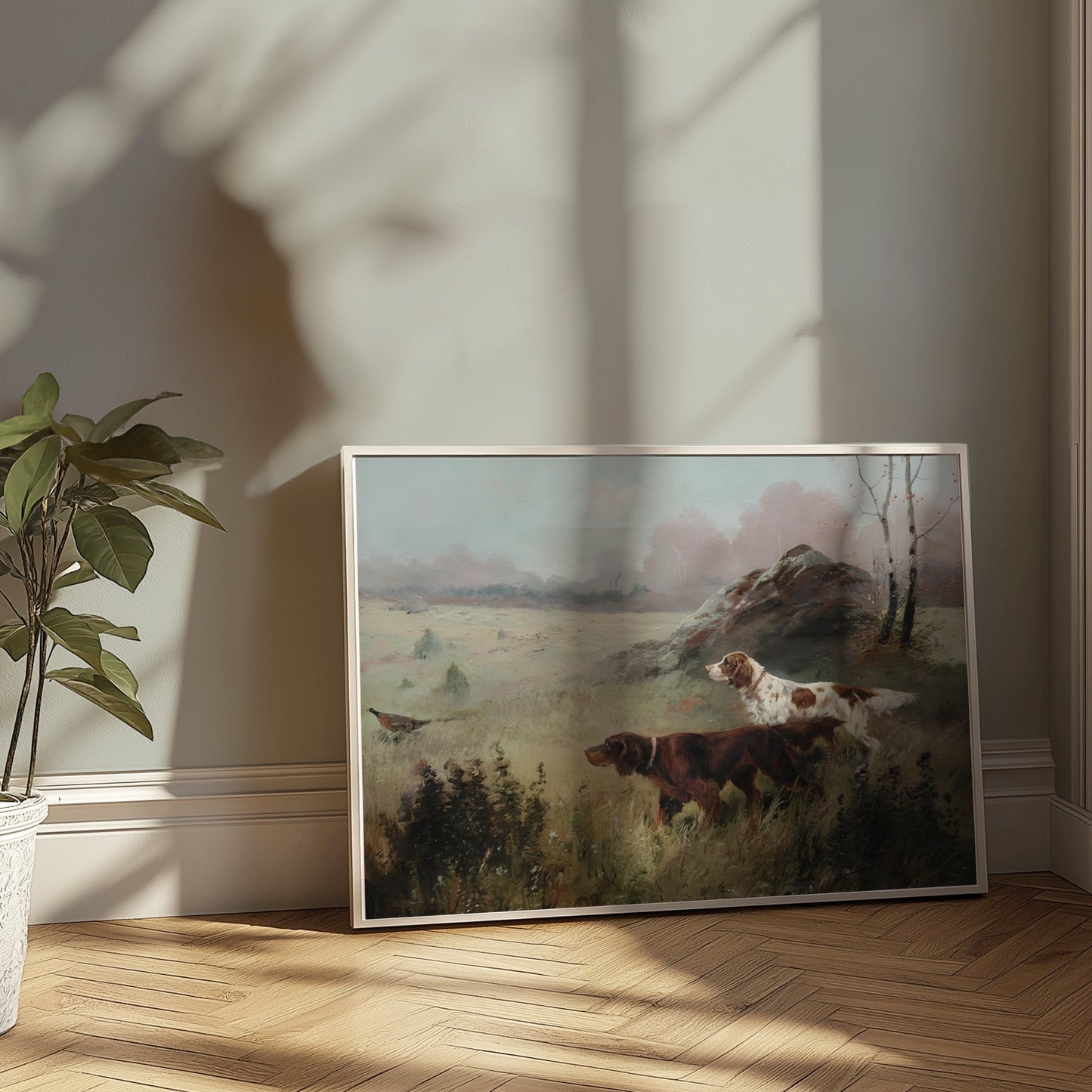 Unframed hunting dogs in misty forest landscape poster leaning against a wall, illuminated by natural sunlight.