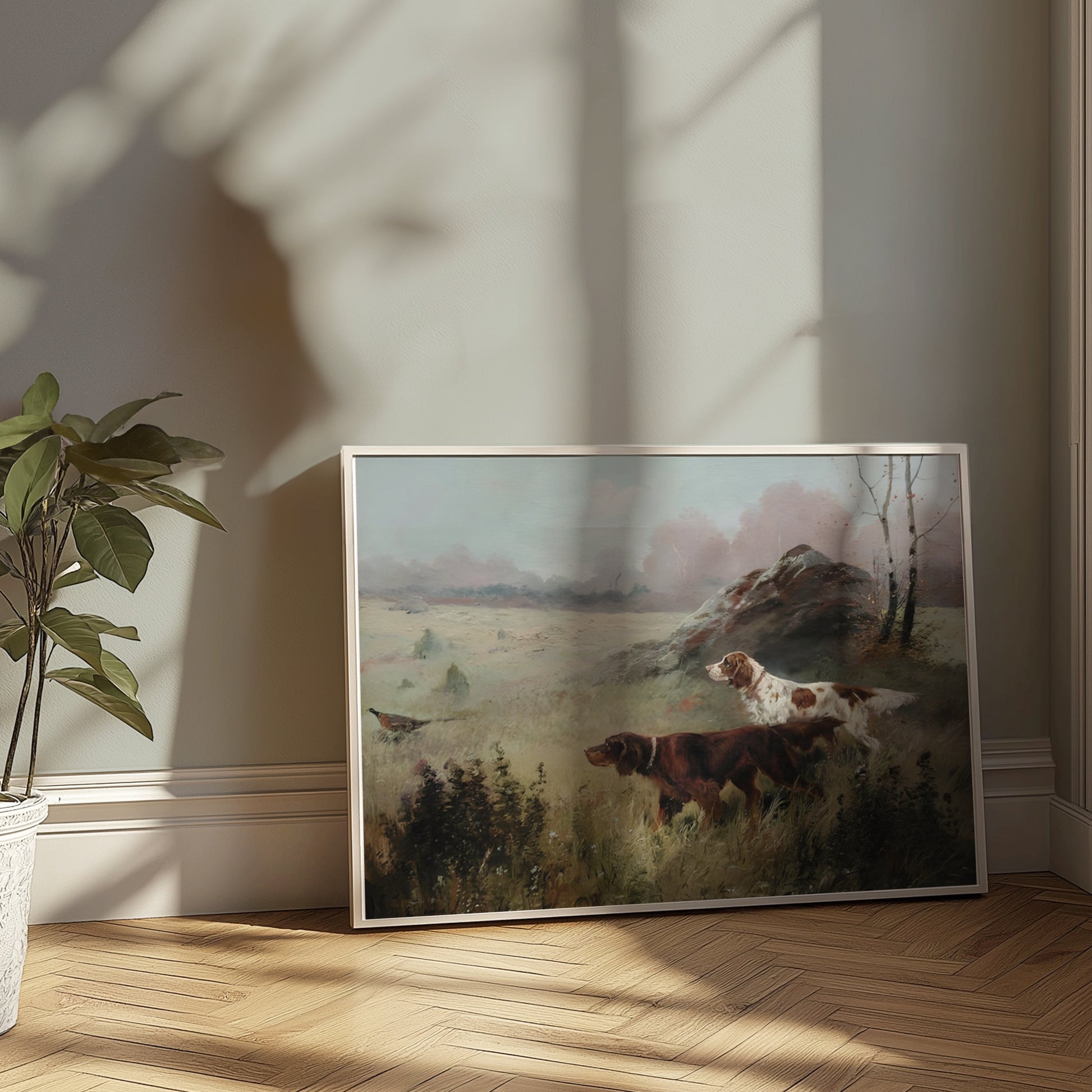 Unframed hunting dogs in misty forest landscape poster leaning against a wall, illuminated by natural sunlight.