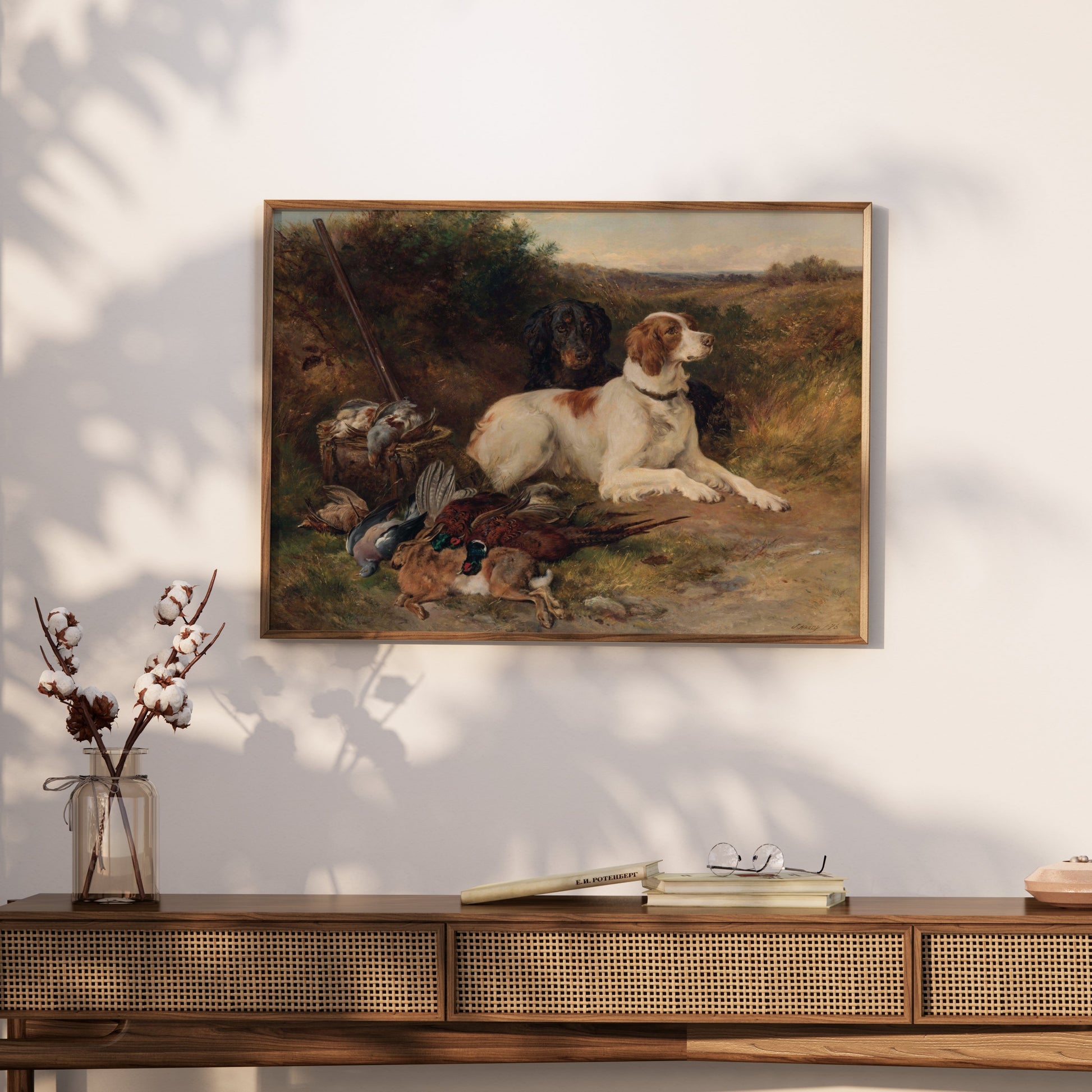 Framed hunting dogs artwork displayed on a wooden console table, ideal for rustic decor and countryside-inspired interiors.