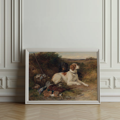 Vintage hunting dogs and game birds artwork in a white frame, leaning against an ornate wall in a classic interior.