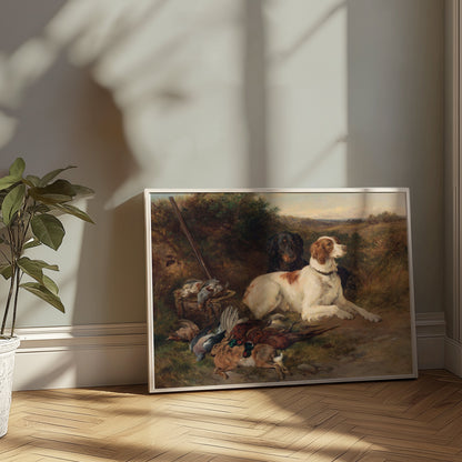 Hunting dogs and game birds artwork in a white frame, placed on a wooden floor with sunlight streaming through a nearby window.