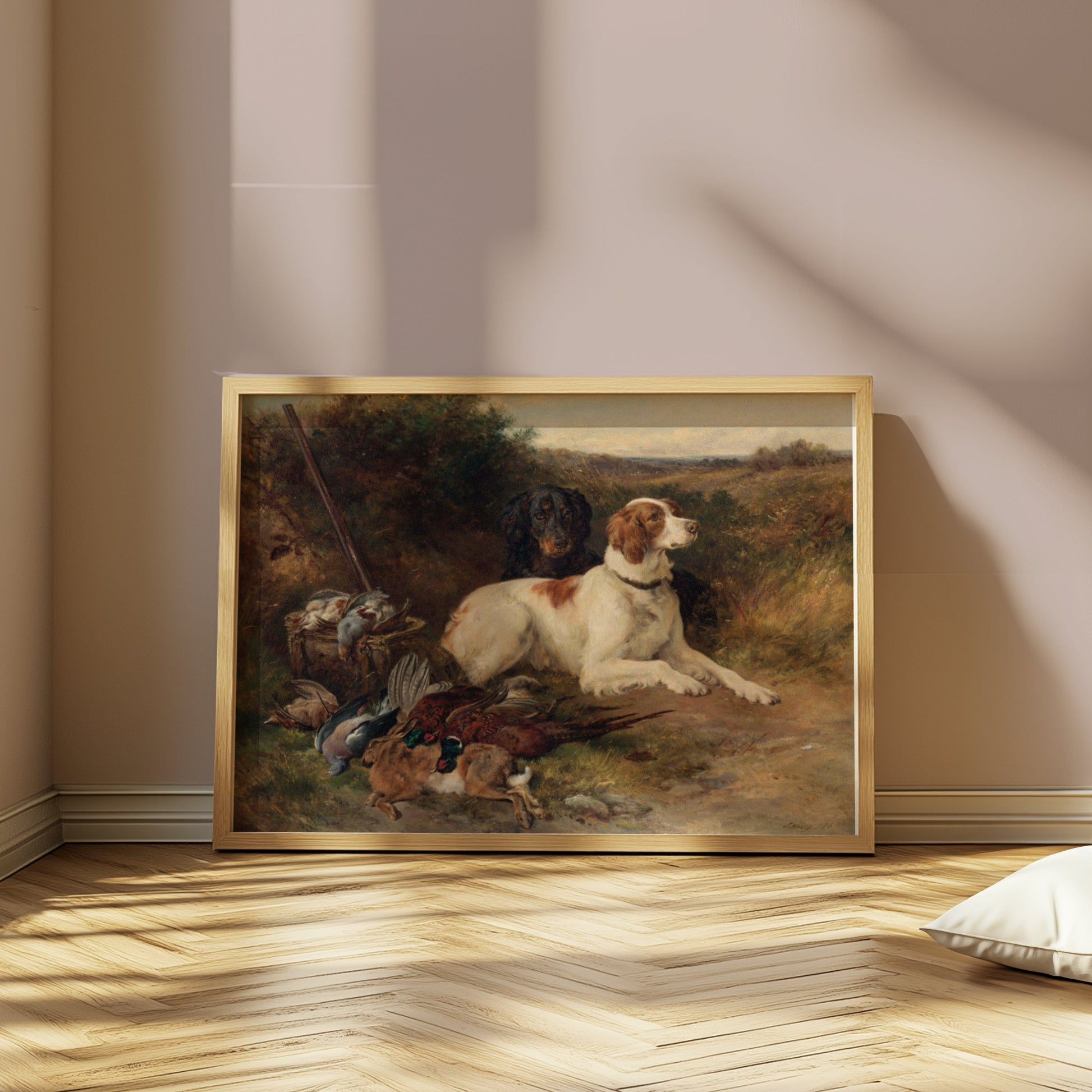 Rustic hunting dogs artwork in a wooden frame, propped against a wall in a softly lit room with herringbone flooring.