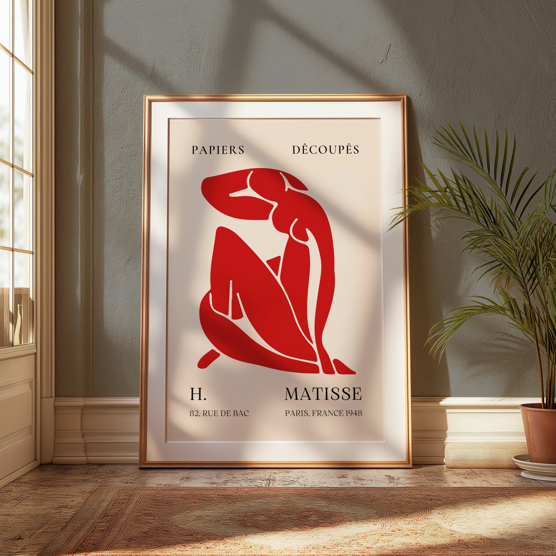 Framed H. Matisse 1948 Papiers Découpés art poster displayed in a sunlit room with a plant, perfect for enhancing home interiors.