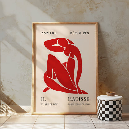 H. Matisse 1948 Papiers Découpés poster in a rustic wooden frame, displayed in a textured space with a checkered stool, adding artistic flair.
