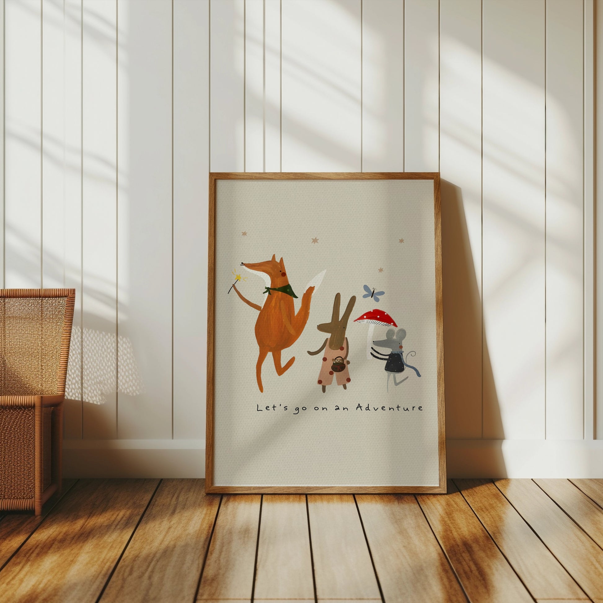 Adventure-themed animal poster in a wooden frame, leaning against a white paneled wall in a cozy, minimalist room.