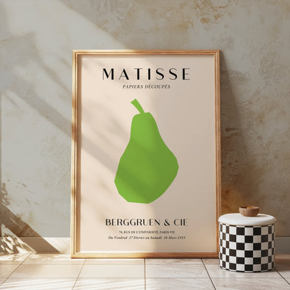 Matisse green pear poster in a wooden frame, styled on a textured wall with a decorative jar, perfect for gallery wall setups.