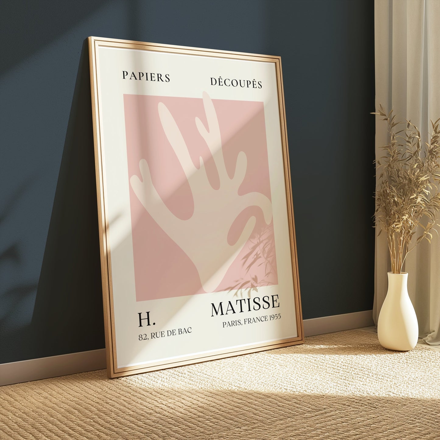 Matisse Coral Hand Inspired Paris Art Poster leaning against a dark wall, styled with natural decor elements for a minimalist aesthetic.