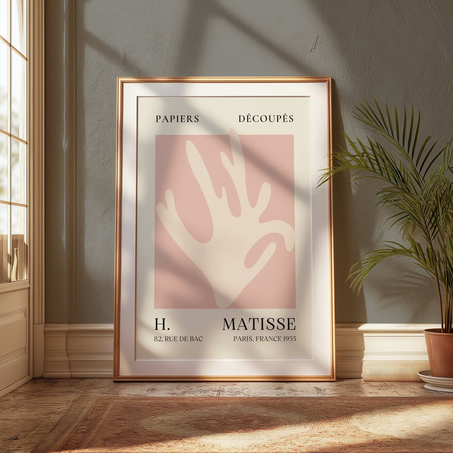 Matisse Coral Hand Inspired Paris Art Poster in a gold frame, styled in a classic interior with natural light and greenery for elegant decor.