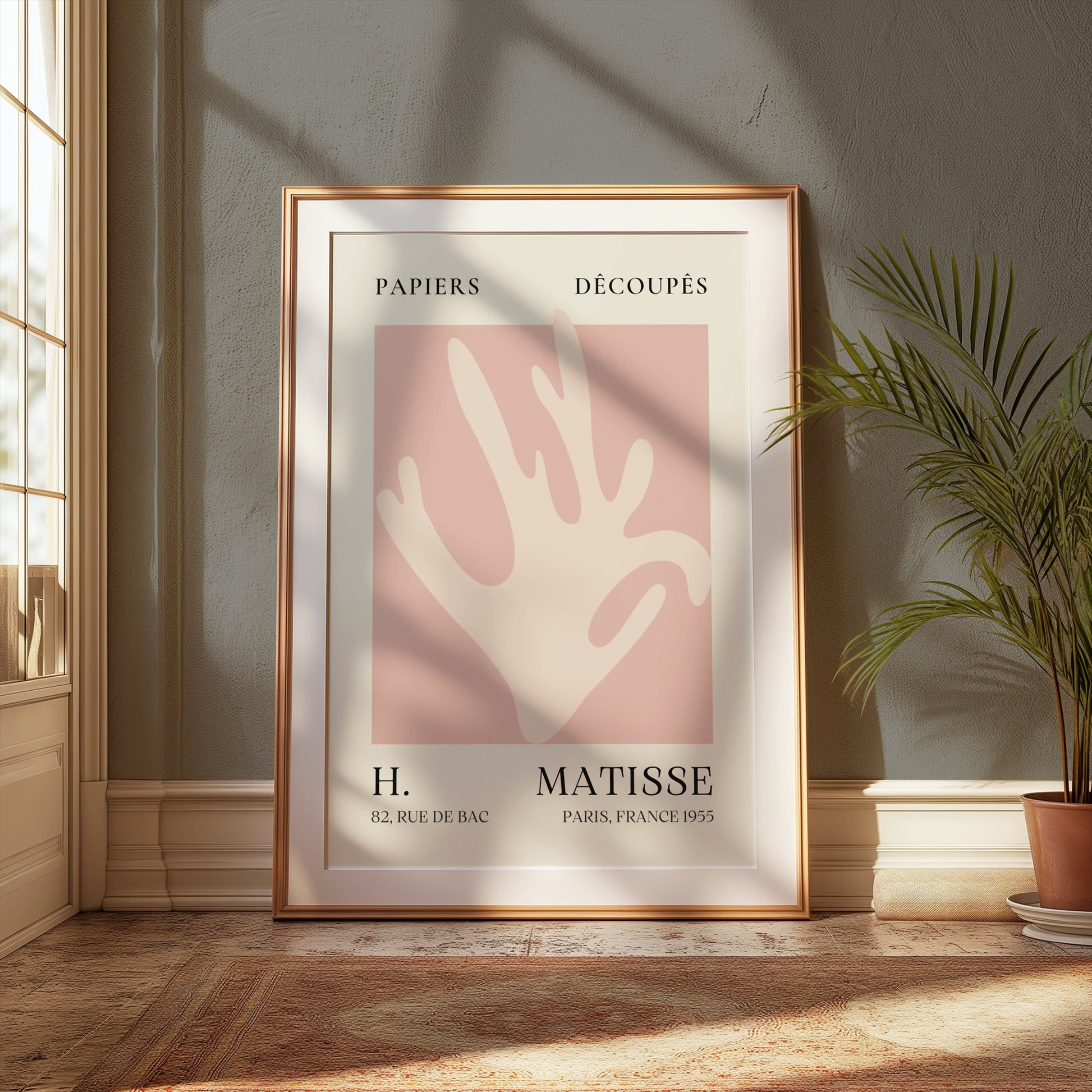 Matisse Coral Hand Inspired Paris Art Poster in a gold frame, styled in a classic interior with natural light and greenery for elegant decor.