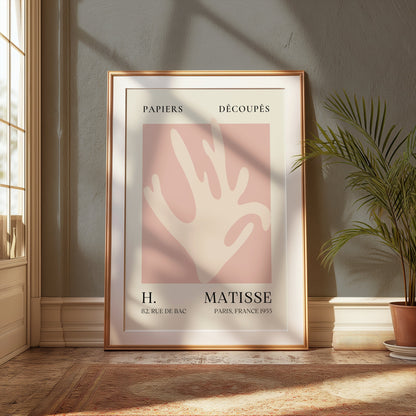 Matisse Coral Hand Inspired Paris Art Poster in a gold frame, styled in a classic interior with natural light and greenery for elegant decor.