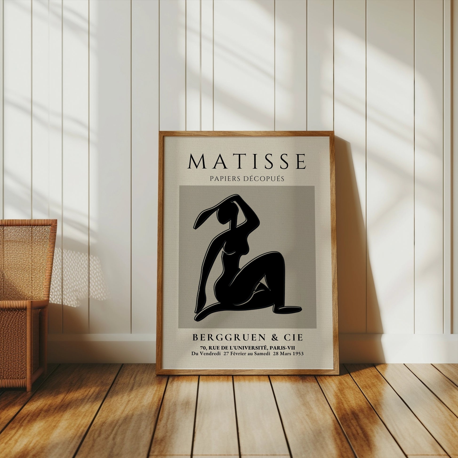 Matisse Exhibition Papiers Decoupés Berggruen Poster in a wooden frame, styled in a bright room with wooden flooring and natural light.