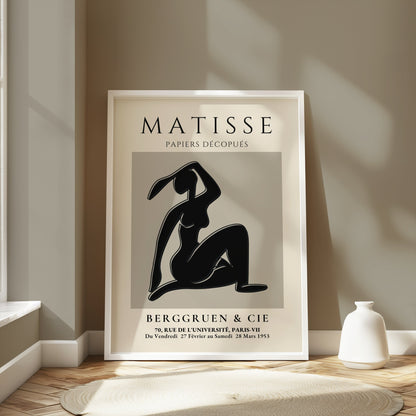 Framed Matisse Exhibition Papiers Decoupés Berggruen Poster styled in a light-filled room with minimalist decor and neutral tones.