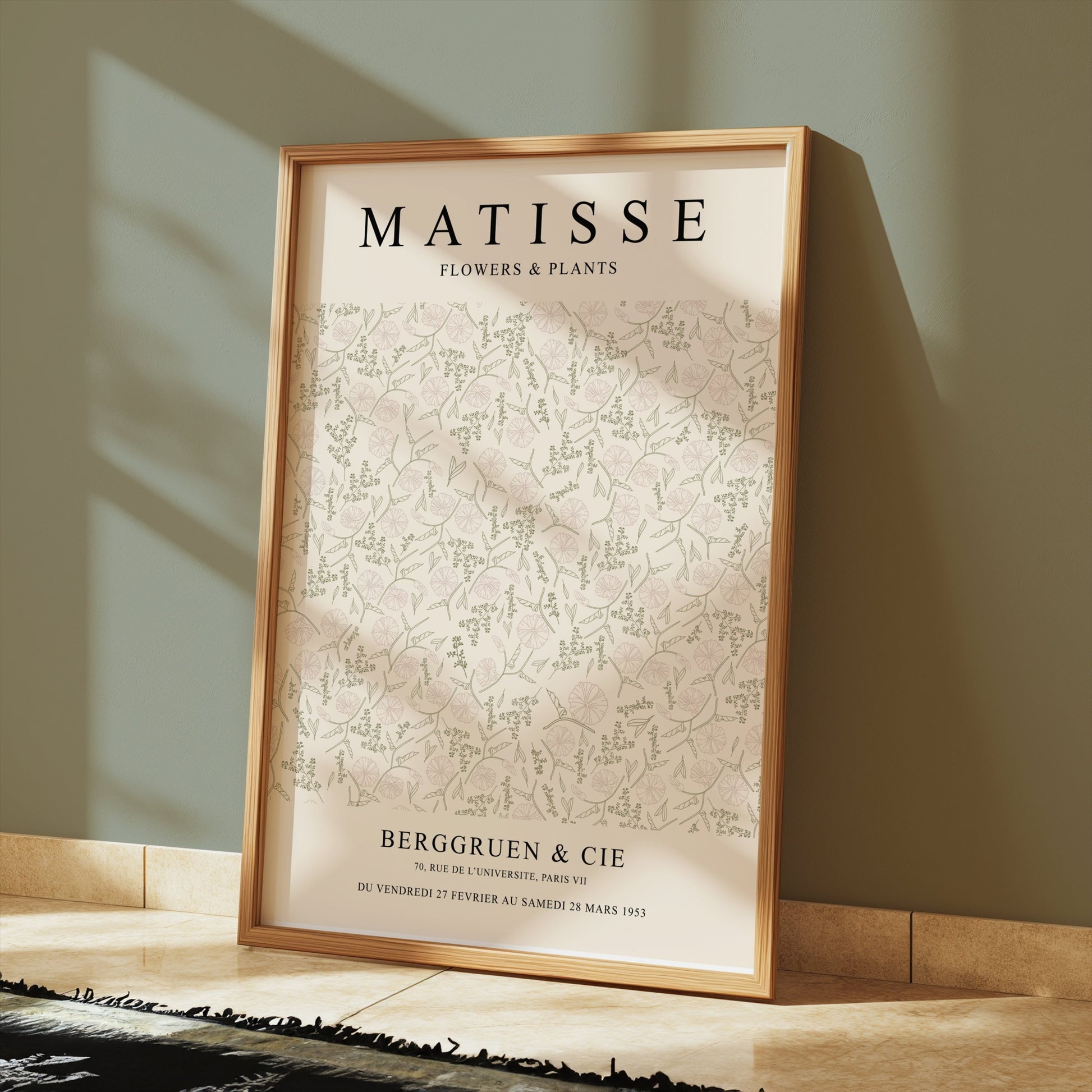 Matisse Flowers and Plants Berggruen and Cie poster in a gold frame leaning against a green wall, styled with elegant flooring.