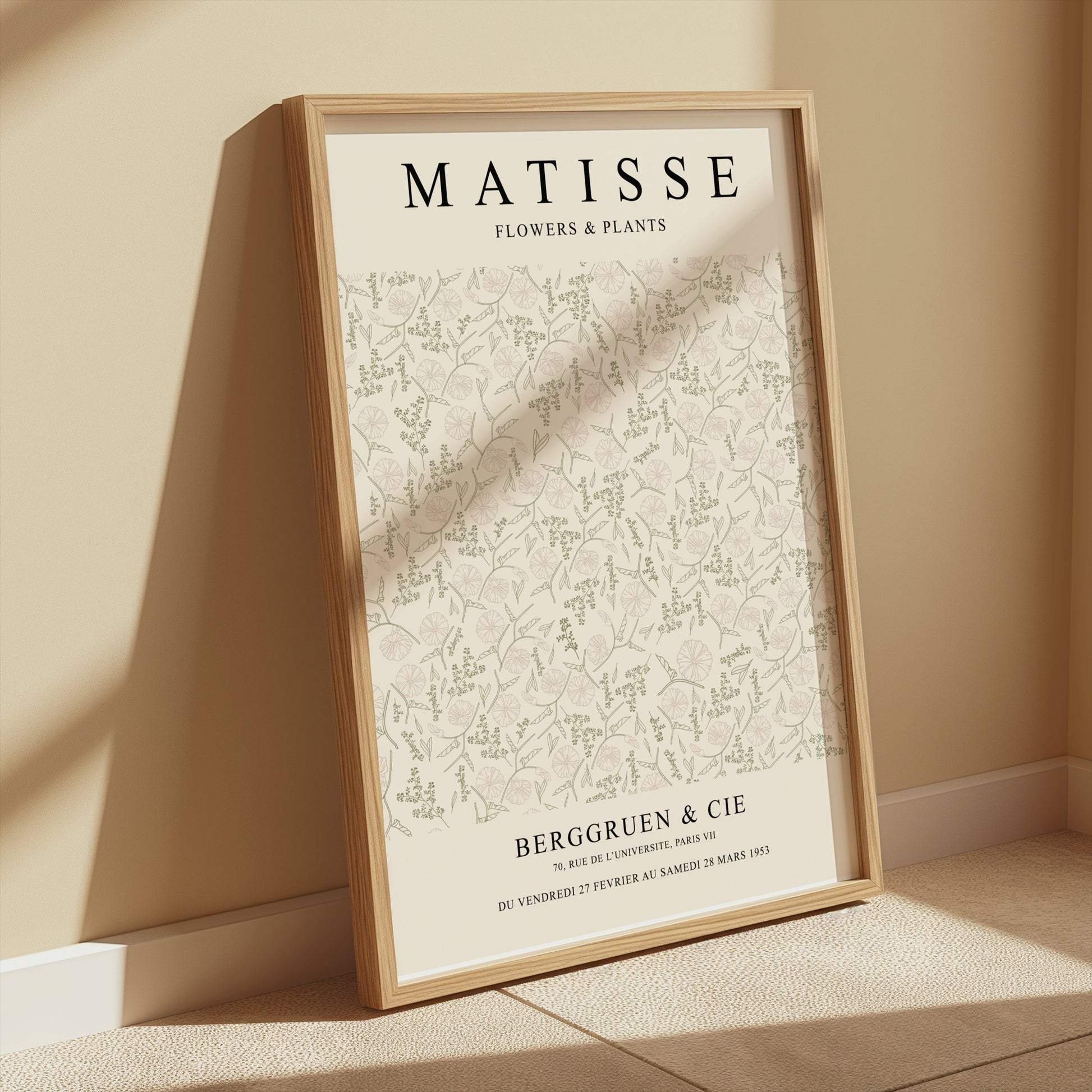 Framed Matisse Flowers and Plants Berggruen and Cie poster leaning against a beige wall, bathed in soft sunlight for a cozy decor vibe.