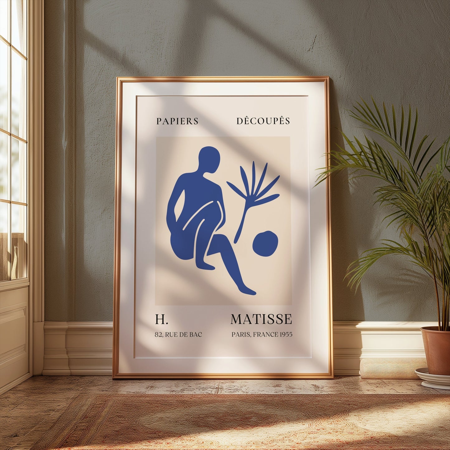 Matisse inspired modern art poster in a gold frame, styled in a classic interior with a potted plant and soft natural light.