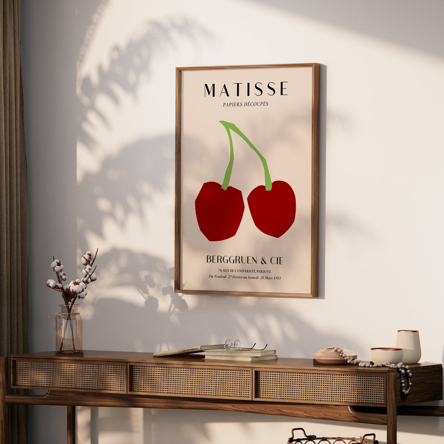 Matisse Papiers Découpés cherry art print poster hung on a white wall above a wooden console table with minimalist decor.