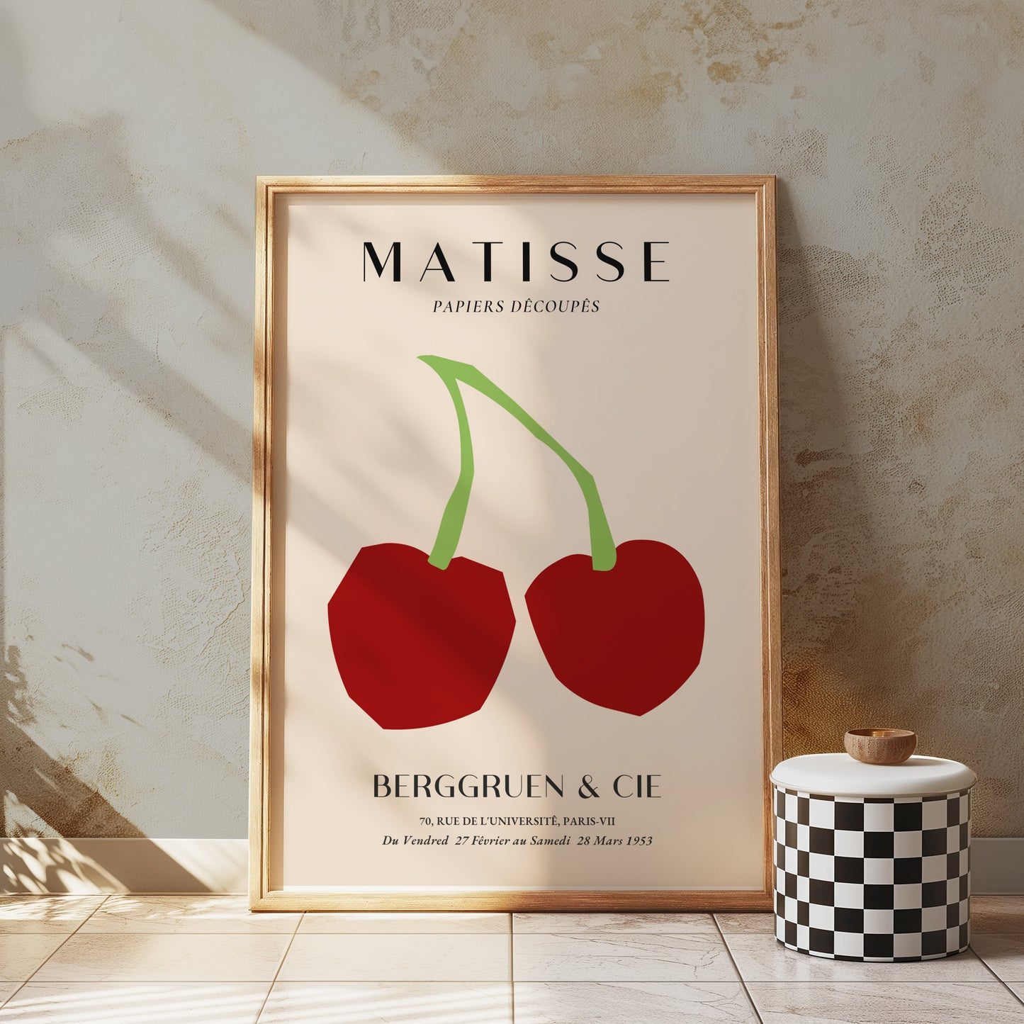 Framed Matisse Papiers Découpés cherry art print poster styled on a textured wall with a checkered decor piece and natural sunlight.