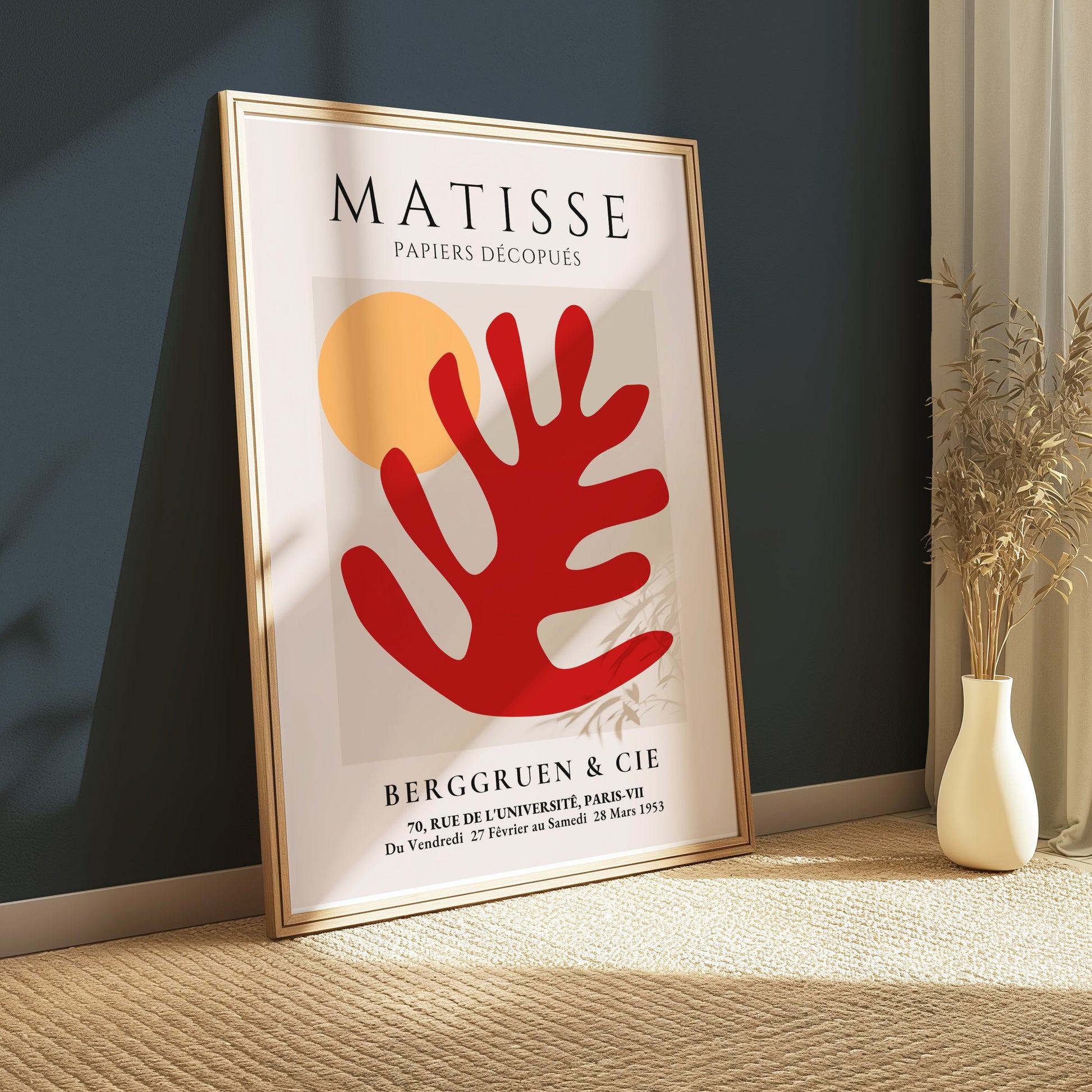 Matisse Art Poster with red coral and orange sun, framed and leaning against a dark green wall, styled with minimal decor in a sunlit room.