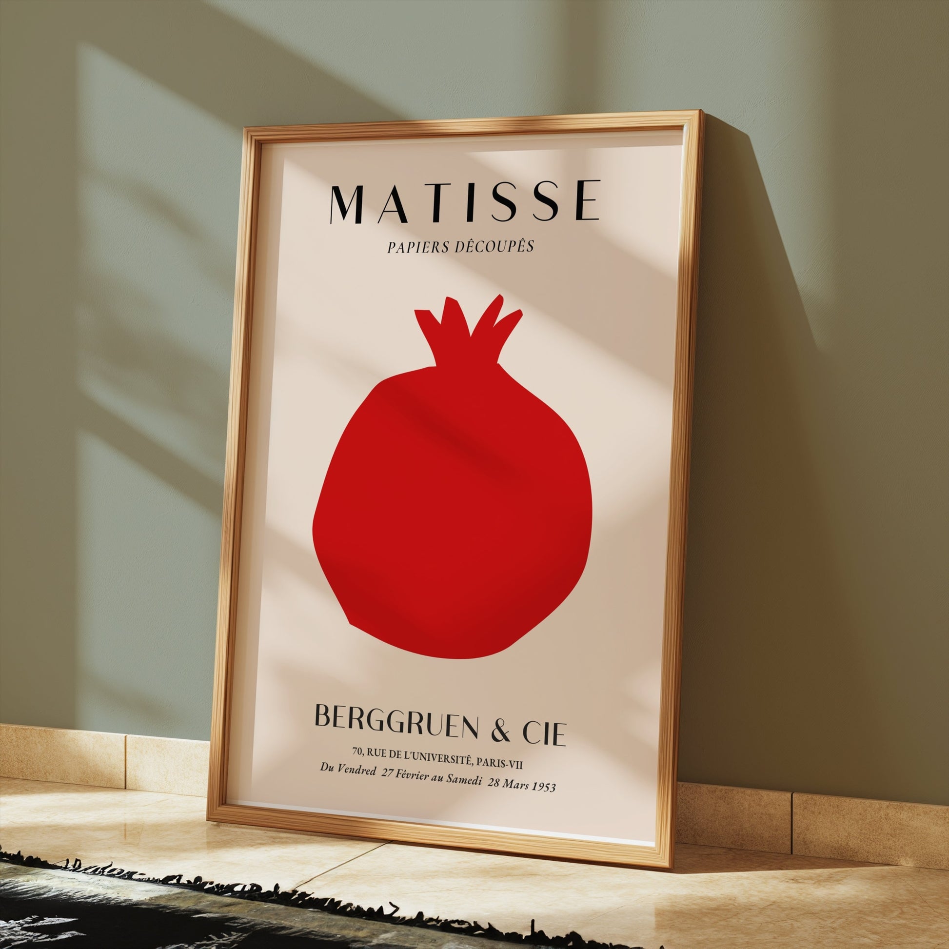 Matisse Papiers Decoupes Berggruen & Cie poster in a gold frame leaning against a wall with sunlight casting shadows on the floor.
