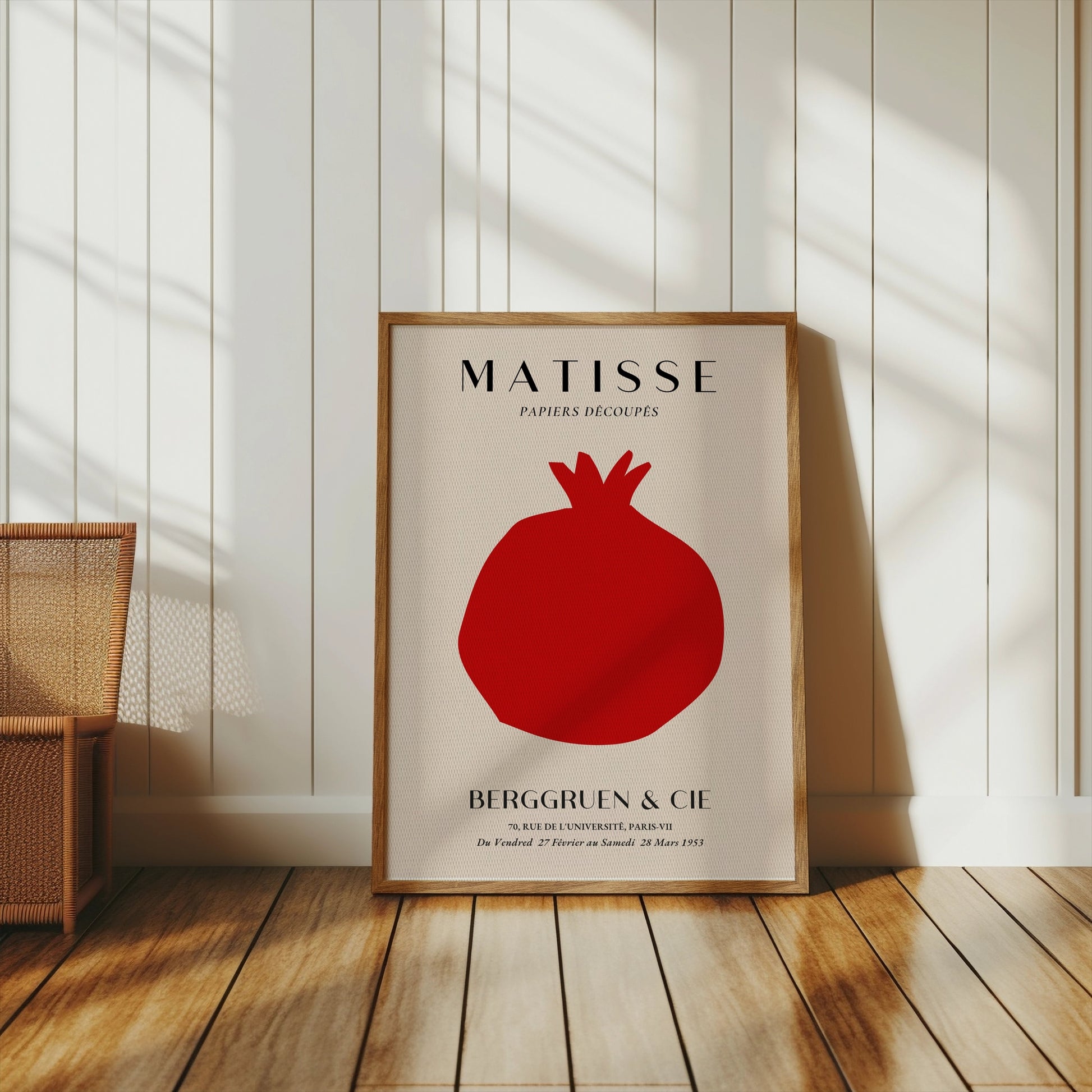 Matisse Papiers Decoupes Berggruen & Cie poster in a wooden frame leaning against a white paneled wall in a cozy, sunlit space.