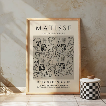 Matisse Papiers Découpés exhibition poster leaning against a textured wall, styled with a checkered decor piece for vintage aesthetics.
