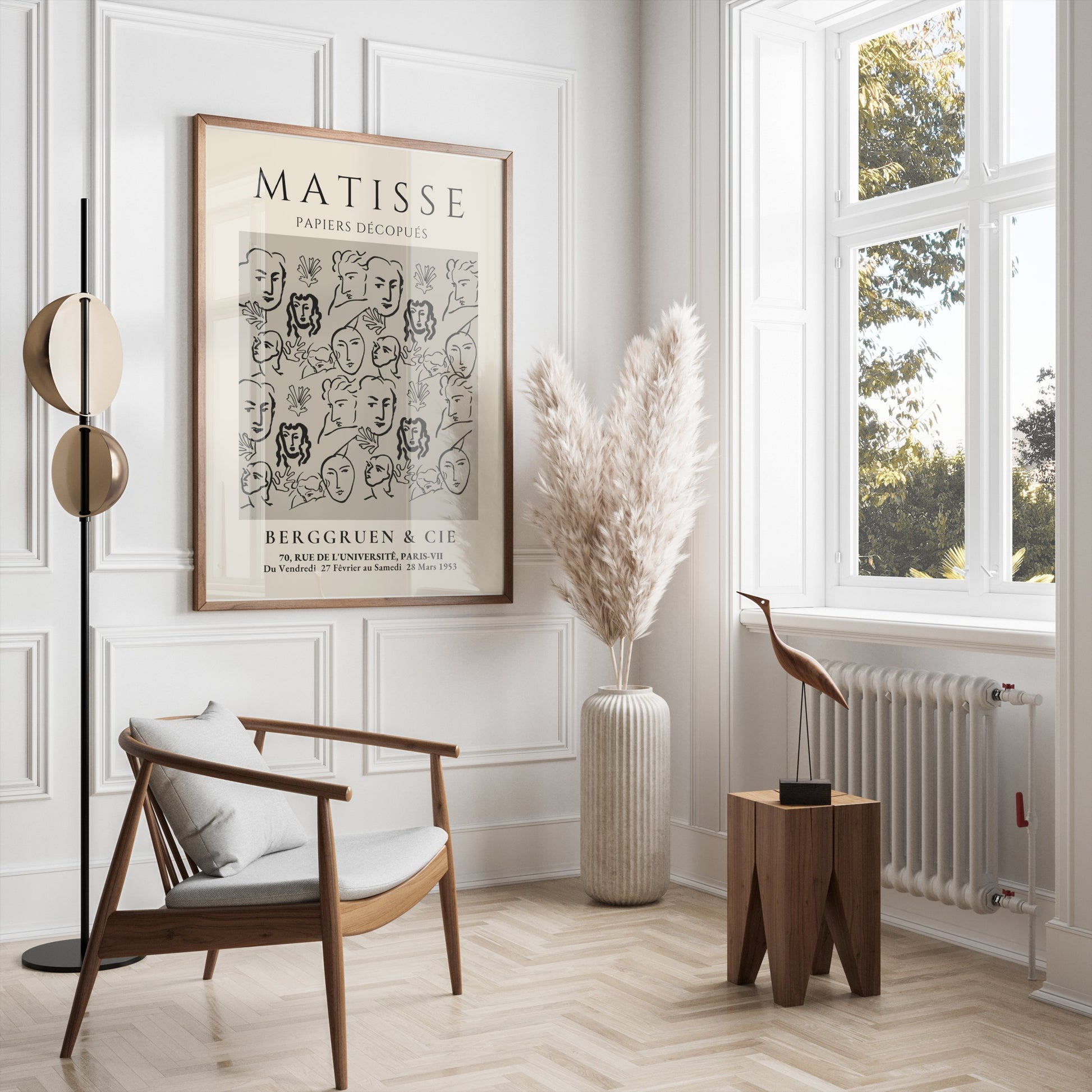 Framed Matisse Papiers Découpés exhibition poster in a bright, elegant living room with modern furniture and pampas grass decor.