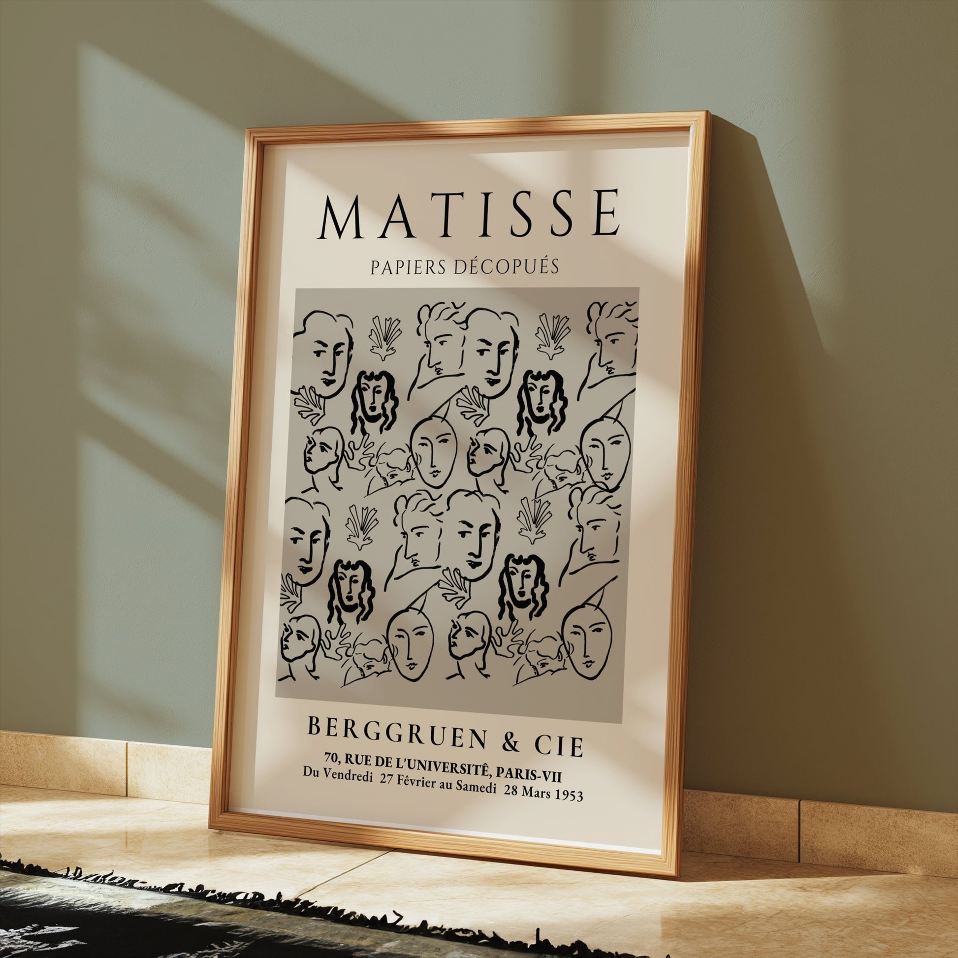Framed Matisse Papiers Découpés exhibition poster resting on a tiled floor, styled in a modern interior with soft lighting.