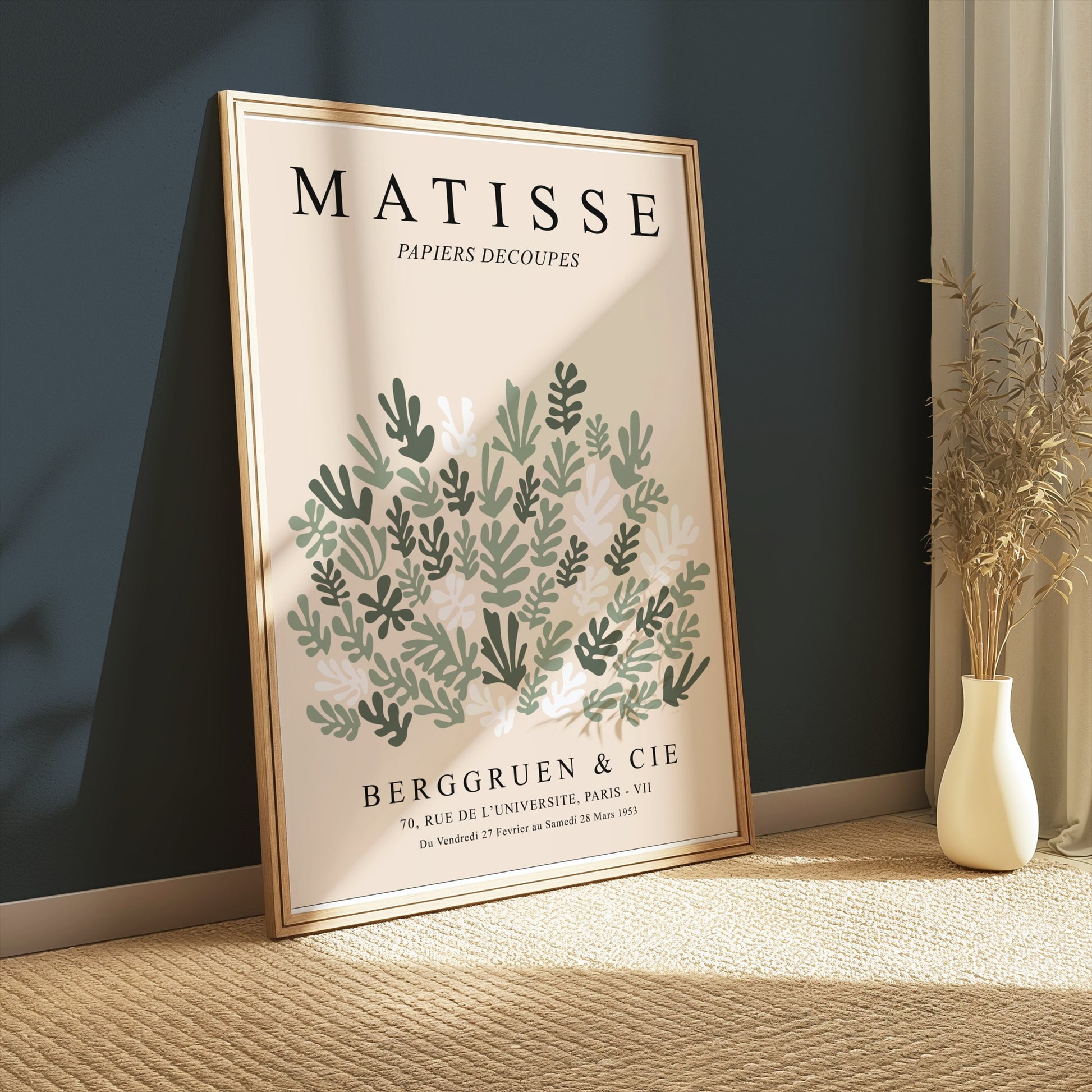 Framed Matisse Papiers Decoupes poster leaning against a dark green wall, featuring botanical cut paper art and soft natural lighting.