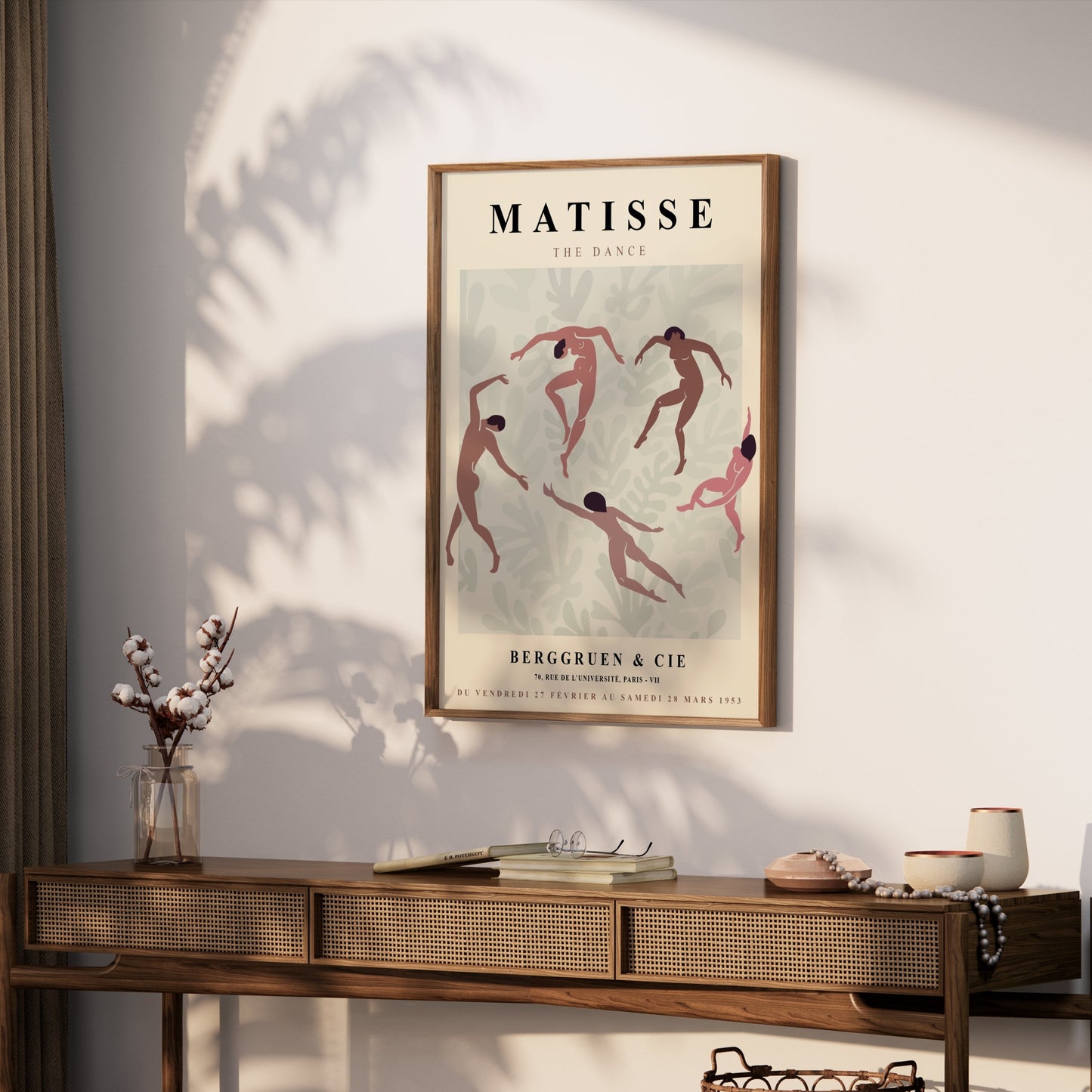 Framed Matisse The Dance exhibition poster displayed on a wooden console table with bohemian decor and natural lighting.