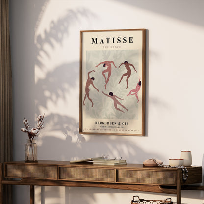 Framed Matisse The Dance exhibition poster displayed on a wooden console table with bohemian decor and natural lighting.