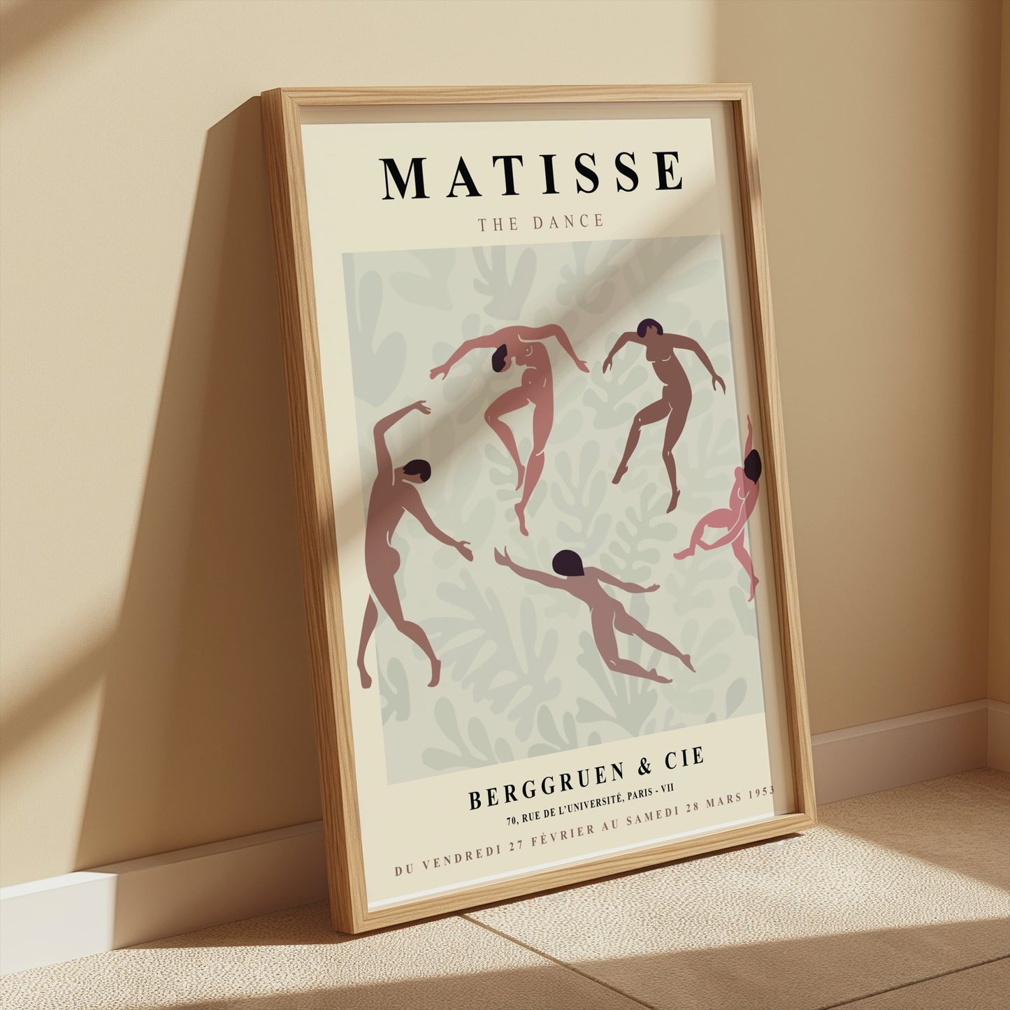 Framed Matisse The Dance exhibition poster leaning against a beige wall with soft sunlight and minimalist decor.