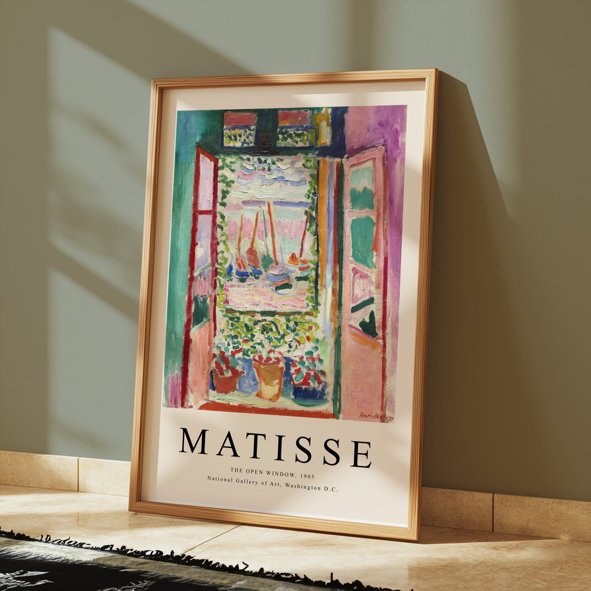 Framed Matisse The Open Window 1905 poster styled on a tiled floor with sunlight streaming through nearby windows.