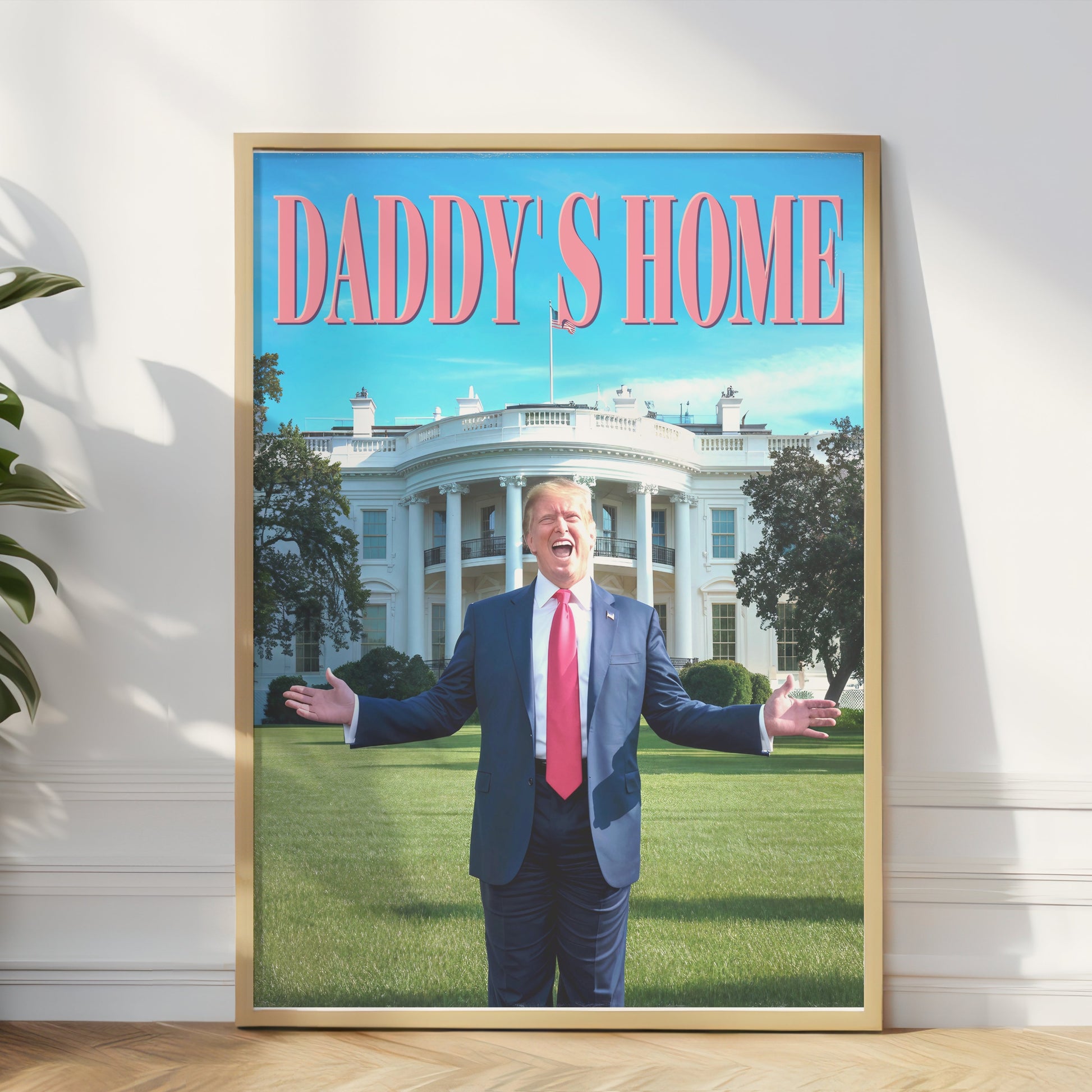 President Donald Trump Daddy's Home poster in a gold frame, leaning against a wall with natural light, enhancing any space with bold political humor.