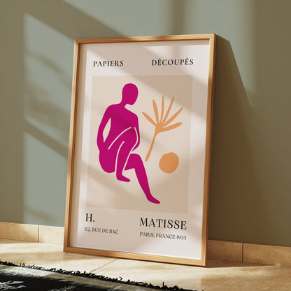 Framed Henri Matisse inspired art print poster placed on a tiled floor with sunlight, featuring bold abstract design for home decor.
