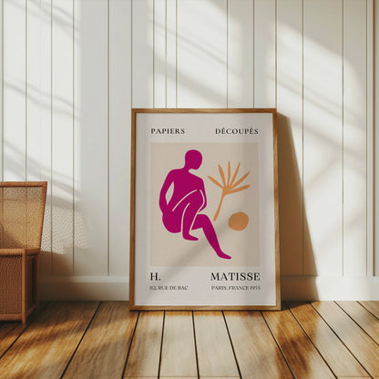 Henri Matisse inspired art print poster in a wooden frame, leaning against a white paneled wall, showcasing modern abstract art for interiors.