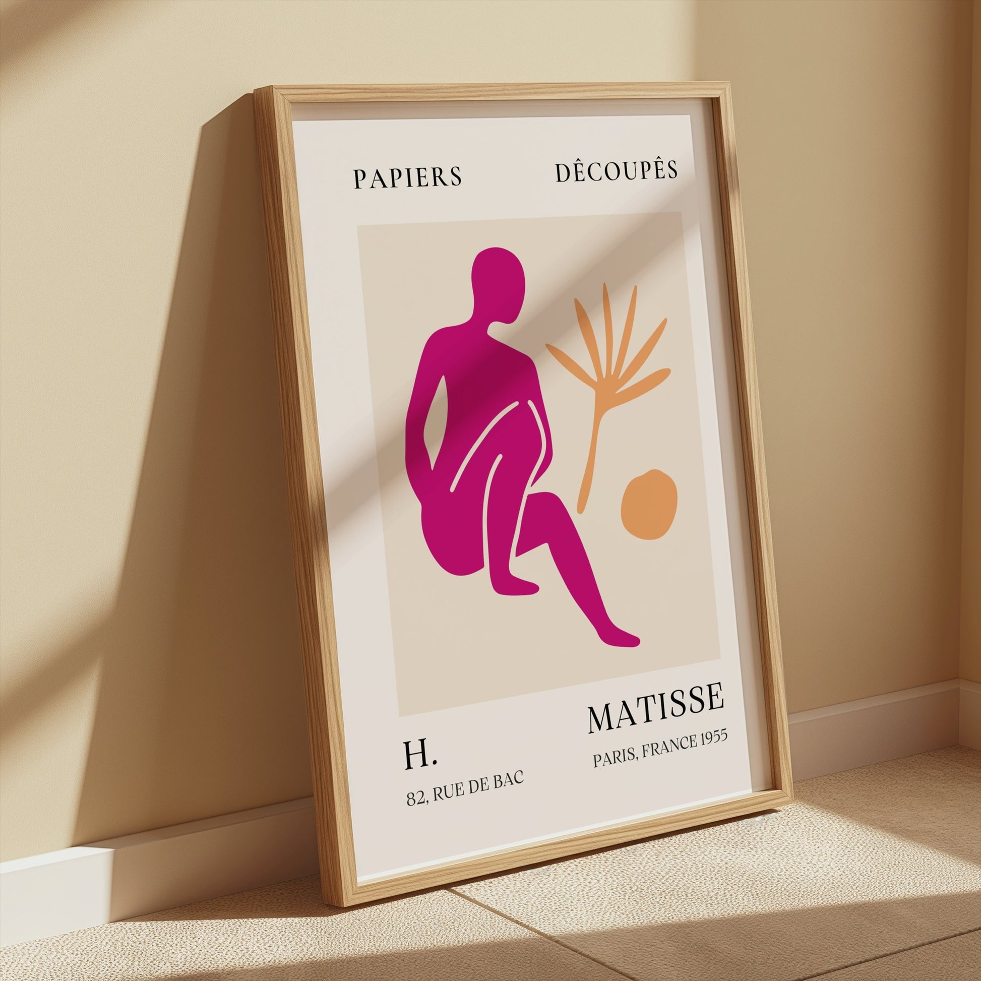 Henri Matisse inspired art print poster in a wooden frame, leaning against a beige wall with sunlight, ideal for stylish home decor.