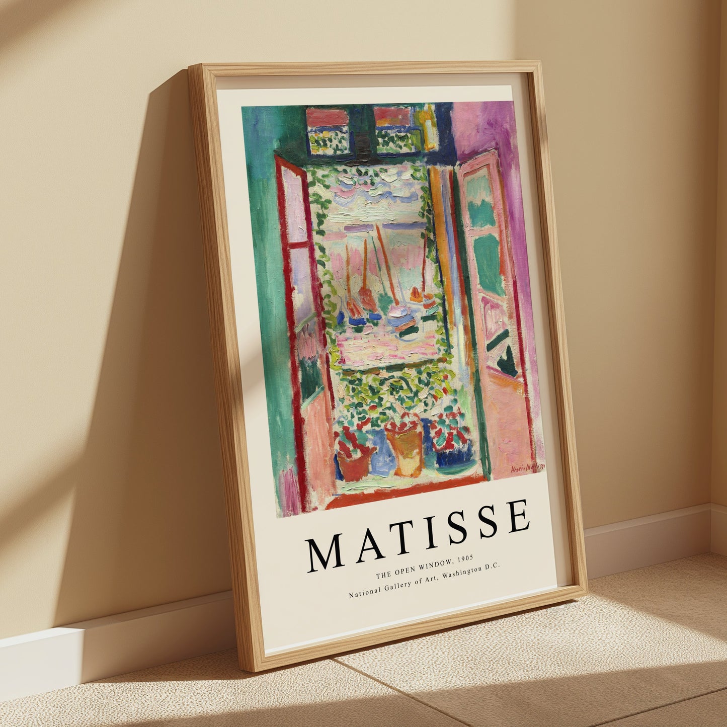 The Open Window by Matisse 1905 framed art print poster leaning against a beige wall, bathed in soft natural light for a warm ambiance.