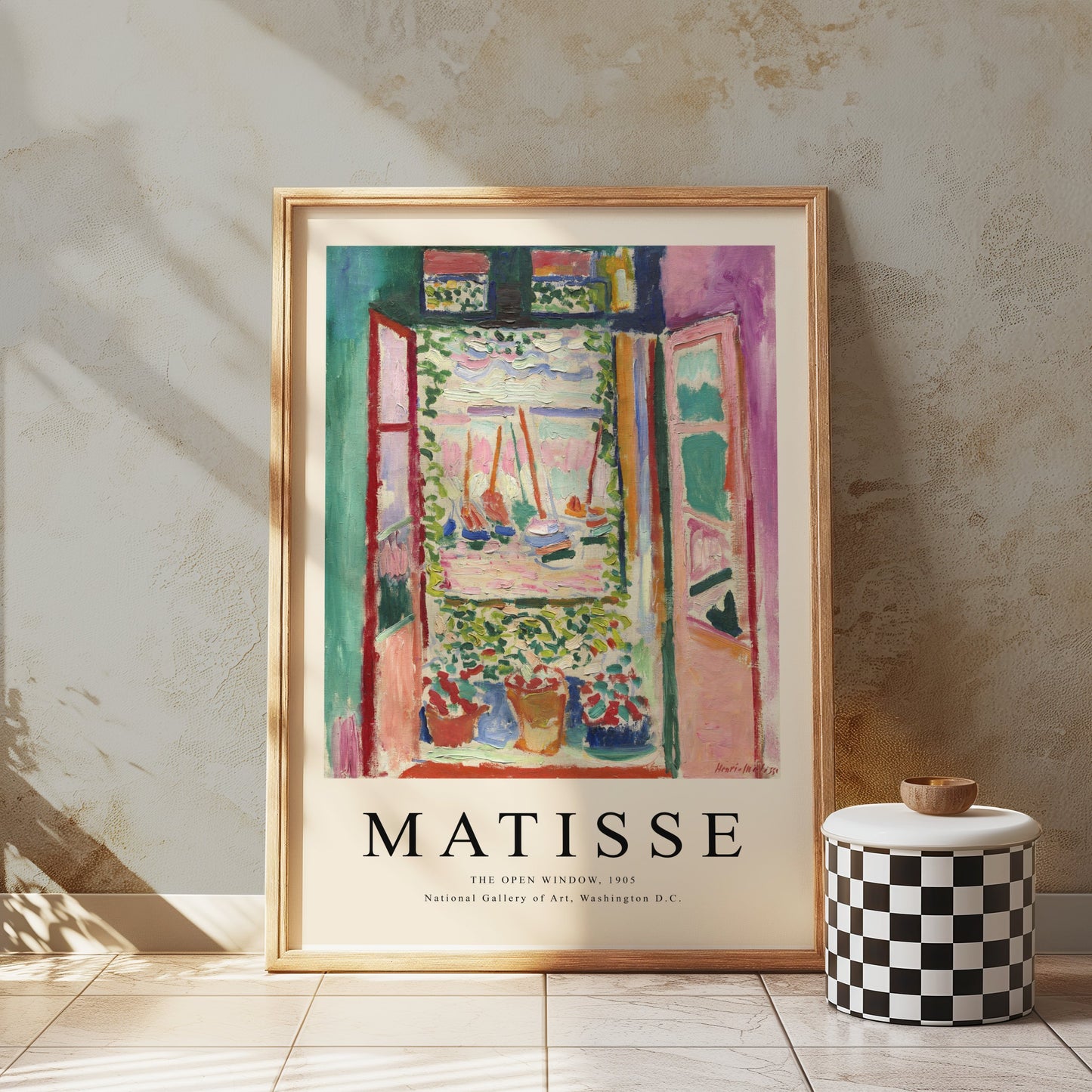 The Open Window by Matisse 1905 framed art print poster leaning against a textured wall, styled with a checkered stool for a modern look.