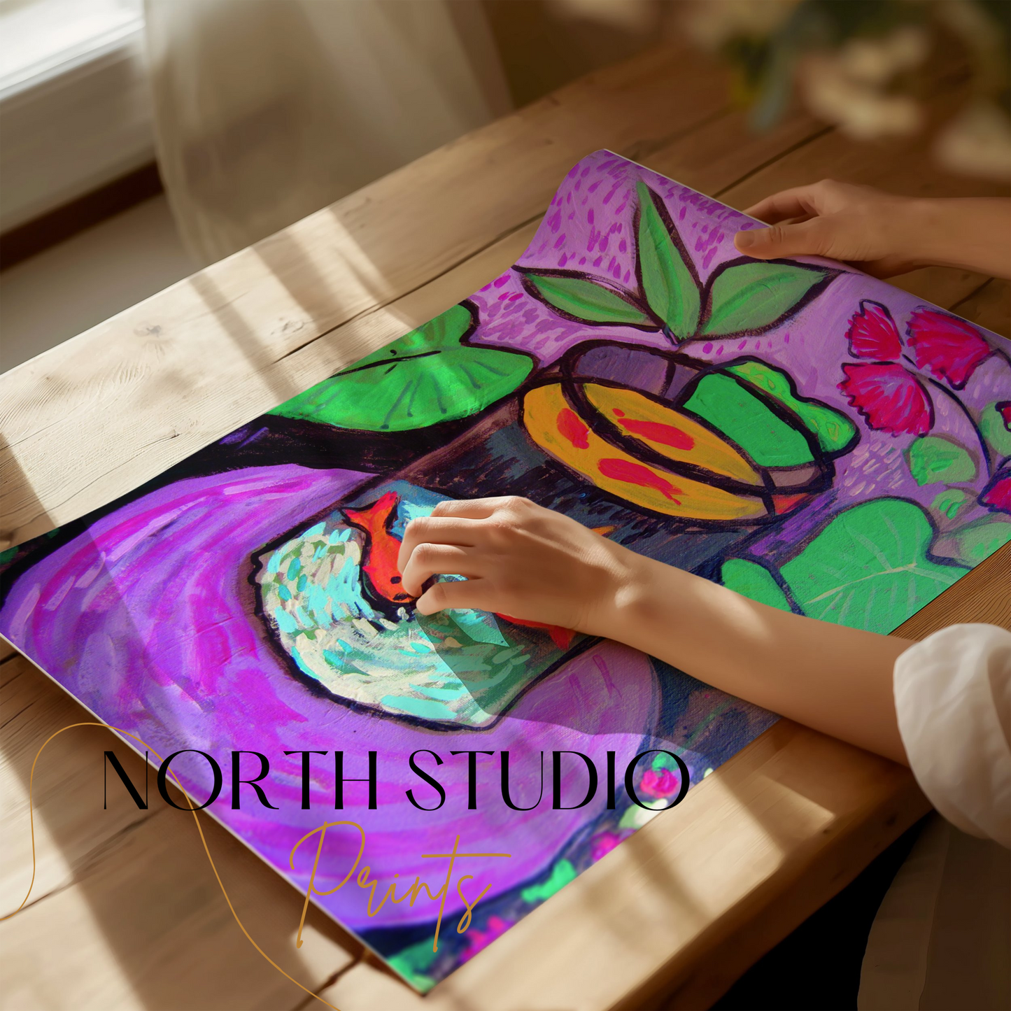 Unframed Matisse-inspired fish poster being rolled out on a wooden table, highlighting its bold colors and unique artwork.