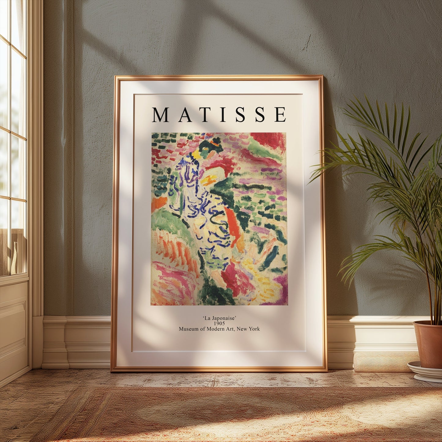 Matisse 'La Japonaise' art print in a gold frame, styled in a cozy, sunlit room with lush green plants and warm tones.