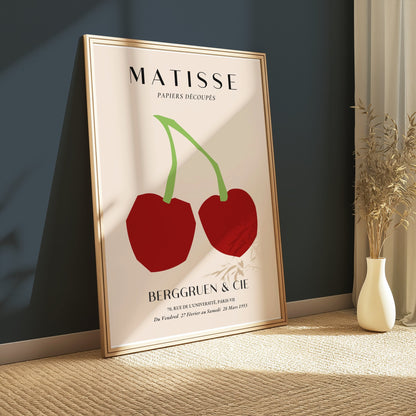 Henri Matisse cherry art print leaning against a dark teal wall, styled with natural light and minimalist decor for modern art enthusiasts.